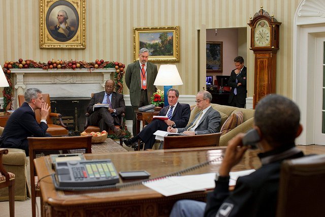 Another late night in the Oval Office as aides listen on speaker phone while the President speaks to