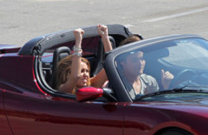 17025885_QWLCWOKAP - Miley Cyrus Photoshoot in a Tesla Roadster
