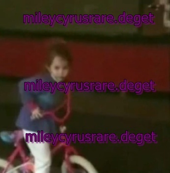 with bicycle - a very rare pics with miley when she was a little girl