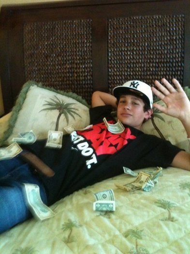 laying in bed , with some money.money.money hahaha
