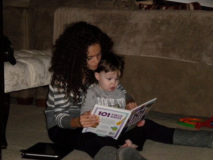 Reading a book to my cousin Dominick - X-mas