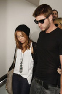 17024735_IUXBWKEQT - Miley Cyrus and Liam Hemsworth at LAX