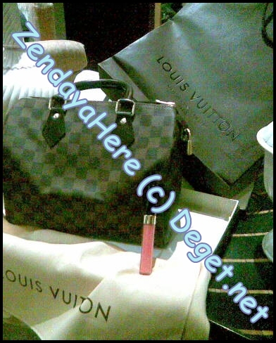 My BIG purchase today..LV purse and Chanel lip gloss.; Two things that girls can&#039;t live without! lol.
