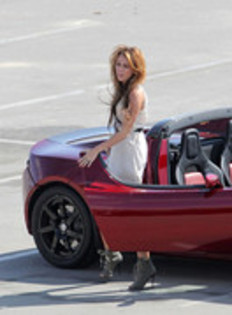 17025879_QWZWQEWIC - Miley Cyrus Photoshoot in a Tesla Roadster