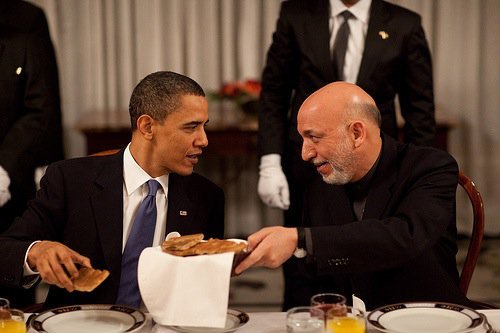 President Barack Obama chats with Afghan President Hamid Karzai during the start of a dinner at the 