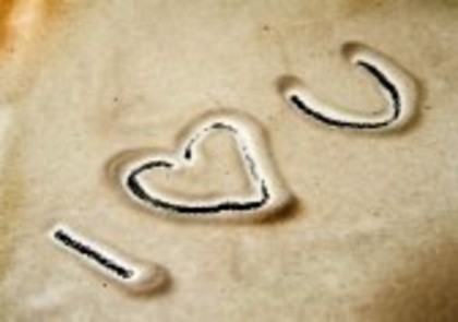 7402036-i-love-you-sign-written-in-dirty-sand
