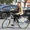 Miley walking with the bike